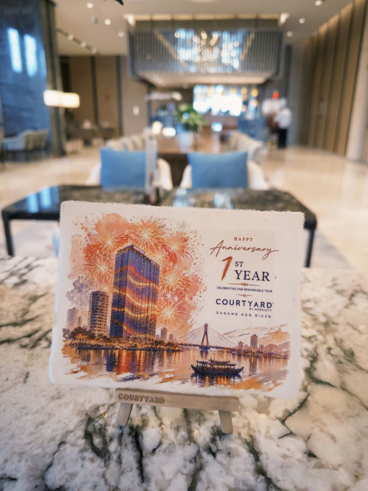 A Dó paper anniversary card displayed on an easel in the hotel lobby
